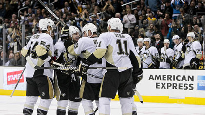 Teammates mob Chris Kunitz after his goal late in the third period tied the game.