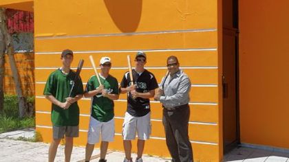 Luis Roberto Clemente, right, joins Pine-Richland High School baseball players, from left, Marcus Colella, Matt Clark and Sam Sedory in front of Roberto Clemente Sports City outside of San Juan, Puerto Rico. The players traveled to Puerto Rico last month to deliver donated baseball equipment to the Roberto Clemente Foundation to benefit children.