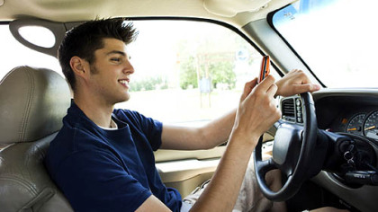 While texting while driving will soon be illegal, use of hand-held devices by drivers isn't, making enforcement by police difficult
