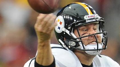 Quarterback Ben Roethlisberger is hit as he begins to pass.