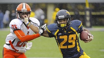 West Virginia's Dustin Garrison, right, fends off Bowling Green's Aaron Foster. Garrison finished the Mountaineers' 55-10 victory in Morgantown, W.Va., with 291 yards rushing.