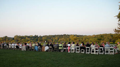 Guests enjoy an Italian dinner outdoors at a 50-foot-long table.