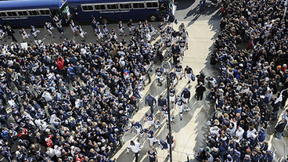 Penn State fans greet their team as they enter Beaver Stadium before the start of the game against Nebraska today.