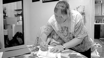 With five kids, Christina Annan has to make sure that homework gets done right after school. She goes to nursing classes at night while husband Bob watches the children.