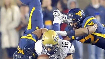 West Virginia's Julian Miller and Najee Goode sack Tino Sunseri on Pitt's final drive of the night. The Mountaineers sacked Sunseri 10 times, including four in the Panthers' last series.