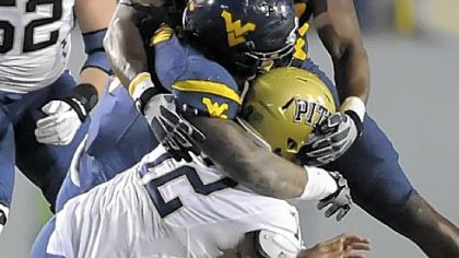 West Virginia's Bruce Irvin and Will Clarke sack Pitt's Tino Sunseri in the fourth quarter Friday.