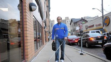 Abbas "Bobby" Quamar, 37, walks through Oakland. He came to the United States after the 1996 accident that blinded him because of the increased study and career opportunities here.