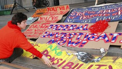 Rachel Beck of Squirrel Hill lays out protest signs on the steps of the City-County Building Tuesday in preparatioin for a rally to protest the conditions in Pennsylvania prisons following the SCI Pittsburgh indictment.