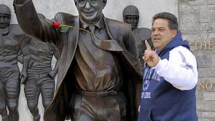 Steve Houck of Orlando, Fla., poses on Penn State's campus next to a statue of Joe Paterno on Friday. Mr. Houck, who drove all night Thursday to attend his first-ever game at Beaver Stadium, said Mr. Paterno "deserved a lot more than just a phone call."