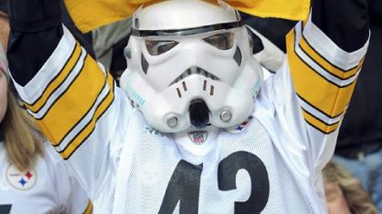 A Steelers fan cheers on his team as they take the field against the Patriots Sunday.