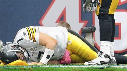 Ben Roethlisberger grabs his right leg late in the fourth quarter after being sacked by the Texans for the fifth time Sunday at Reliant Stadium in Houston.