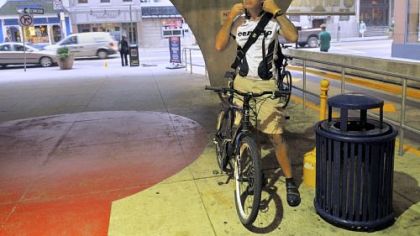 Stephen Taylor, 48, who commutes to Downtown from Glenshaw five days a week, adjusts his helmet before parking his bicycle at a garage on Smithfield Street.