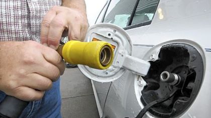 The hose end fits over the fuel tank opening.