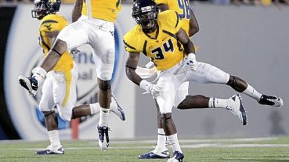 West Virginia's Bruce Irvin (11) and Ishmael Banks (34) celebrate a defensive play against Marshall in the third quarter Sunday at Mountaineer Field.