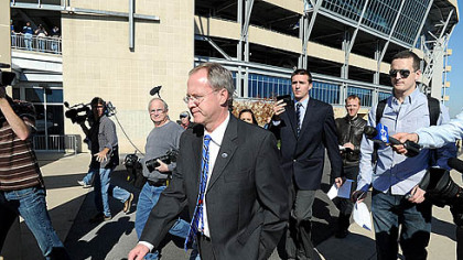 Penn State sports information director Jeff Nelson walks away from the media outside the Beaver Stadium after announcing the cancellation of Coach Joe Paterno's weekly press conference.