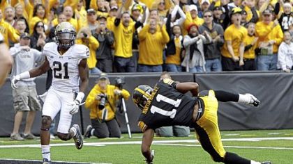 Iowa wide receiver Kevonte Martin-Manley (11) tumbles into the end zone with a 22-yard touchdown catch in front of defensive back Buddy Jackson in the fourth quarter. The touchdown was part of a 21-point comeback by the Hawkeyes.