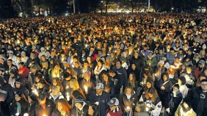 Students gather at Old Main on Friday night for a candlelight vigil for the victims of the sex abuse scandal.
