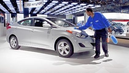 Charles Lee wipes down a Hyundai Elantra during the North American International Auto Show in Detroit in January. Through August, Elantra's sales were up 46.8 percent, according to Automotive News.