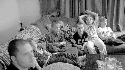 Bob plays a video game with Robert Jr., (third from left), while Raine, Ashton, Laurel and Autumn watch.