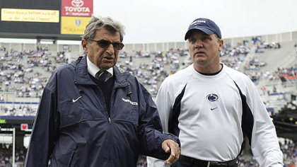 Penn State interim football coach Tom Bradley, right, walks with former Coach Joe Paterno in this 2009 photo.