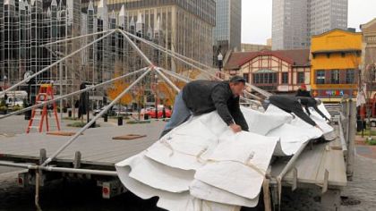 The tarp is pulled into place Thursday for the stage at Market Square for Light Up Night. Entertainment in the square begins at 5 p.m. Friday. Events at other Downtown venues also start at dusk, culminating with fireworks over the Clemente Bridge at 9:38 p.m. Noontime events for the holiday season will take place at the City-County Building and at U.S. Steel Tower Plaza.