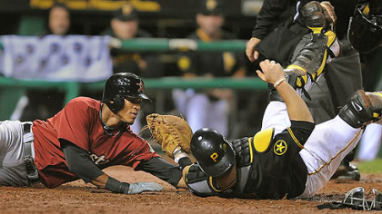 Catcher Ryan Doumit tags out the Astros' Jimmy Paredes at the plate to help the Pirates get out of the eighth inning.