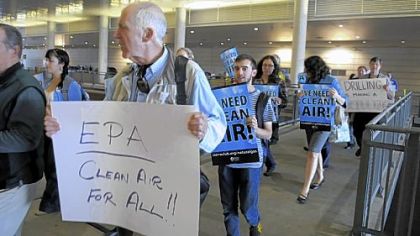 Demonstrators march on Tuesday outside the David L. Lawrence Convention Center during the hearing.