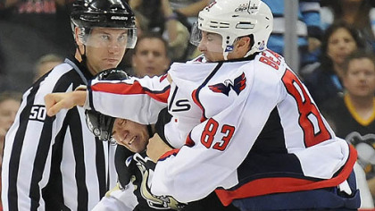 The Penguins' Arron Asham fights the Capitals' Jay Beagle in the third period Thursday. Asham apologized for his antics after knocking Beagle to the ice.