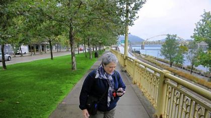 Ruth Kramer of New York uses a GPS to lead a geocaching trek through Downtown.