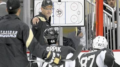 Head coach Dan Bylsma goes through a training camp drill on Sunday at Consol Energy Center
