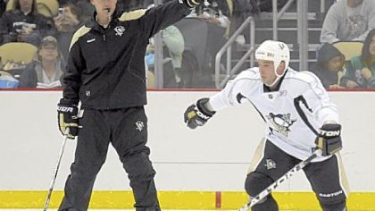 Dan Bylsma, left, sends Steve Sullivan off on a drill at Penguins training camp Sept. 18 at Consol Energy Center.