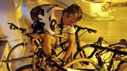 Stephen Taylor sets his bike lock while parking at a garage Downtown.