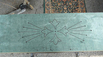 Brenda Carter of Squirrel Hill repurposed a piece of engraved slate from a fireplace as a top for an old wrought-iron table base.