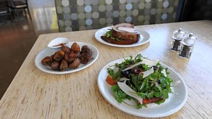 The Rocket (an arugula salad), Crispy Taters (fried potatoes with curry ketchup) and the Porchetta (boneless pork roast) at The Porch, a new restaurant scheduled to open Nov. 14 on Schenley Plaza in Oakland.