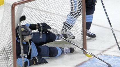 Kris Letang slides into the goal net after a Buffalo Sabres score by Nathan Gerbe in the first period Saturday.