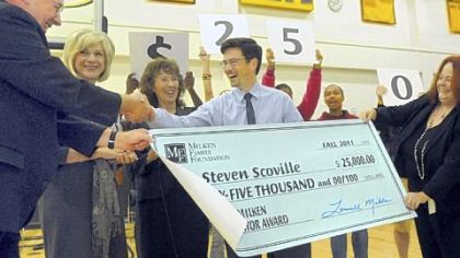 Pittsburgh Brashear High School physics teacher Steve Scoville gets congratulations as he receives a Milken Educator Award in a surprise ceremony Tuesday at the school. The award comes with a $25,000 prize. He's one of 40 educators nationwide receiving the honor. At left is retired Langley High School teacher Ed Henke, who won the award in 1997.