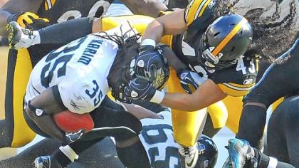 Troy Polamalu tackles Jaguars running back Deji Karim for a loss in the second quarter Sunday at Heinz Field.