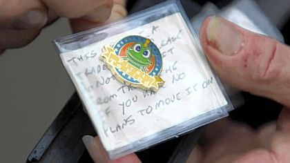 A "geo-coin" is left behind at a Downtown cache.