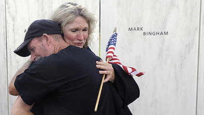 Alice Hoagland, mother of Mark Bingham, who died on Flight 93, hugs Iraqi war veteran Glenn Crutchfield of Coal Hill, Ark. The Wall of Names has the names engraved of the 40 victims of the Flight 93 crash.