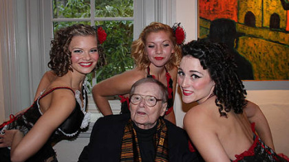 Binai exhibit Artist Paul Binai surrounded by Kit Kat girls during the opening gala of his 50 year retrospective at IUP's Sutton Hall