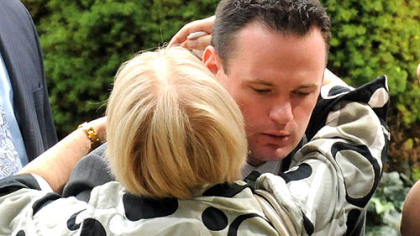Pittsburgh Mayor Luke Ravenstahl hugs a mourner after funeral services for Mary Saflin at Oakmont's St. Irenaeus Catholic Church. Ms. Saflin, 72, of Oakmont, was one of four people who died in the Aug. 19 flash flood in the East End. Mr. Ravenstahl was out of town when the flood hit.