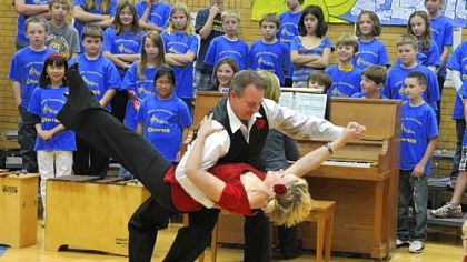 Howe Elementary School teachers Jason Kukic and Caylin Charrie do a tango for students. The dance was part of an assembly welcoming two students and their teacher from Uruguay; they will be spending two weeks in Pittsburgh.  Live video from the assembly was streamed back to the school in Uruguay.