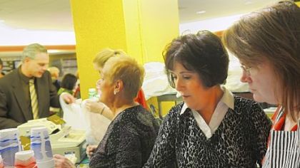 Jim's wife, Libby Calato, second from right, helps tend a cash register.