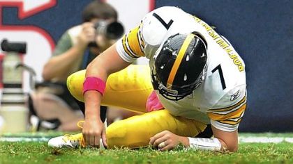 Steelers quarterback Ben Roethlisberger tries to make it to his feet after being sacked for the seventh time against the Texans Sunday.