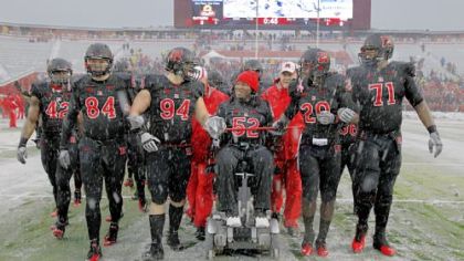 EMOTIONAL KNIGHT Former Rutgers player Eric LeGrand (52), paralyzed in a game against Army last season, led the Scarlet Knights onto the field at Rutgers before a  game Saturday against West Virginia.