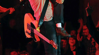 Bruce Springsteen holds up a young fan at Soldiers & Sailors Memorial Hall in Oakland on Nov. 3.