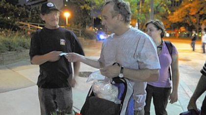 Dr. Jim Withers hands medicine to Raymond Sager.