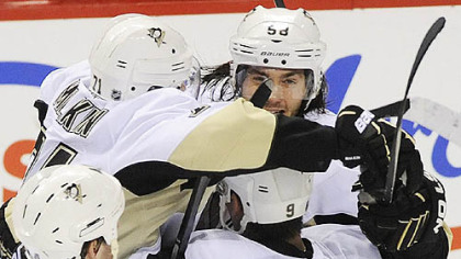Kris Letang, right, is mobbed by teammates after scoring in overtime for the win.