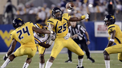 West Virginia's Darwin Cook, middle, looks to corral a loose ball in the Mountaineers' game vs. No. 2 LSU Saturday night.