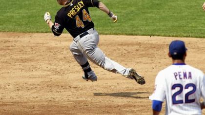 Alex Presley rounds second base and heads to third with a triple in the third inning Friday against the Cubs in Chicago.